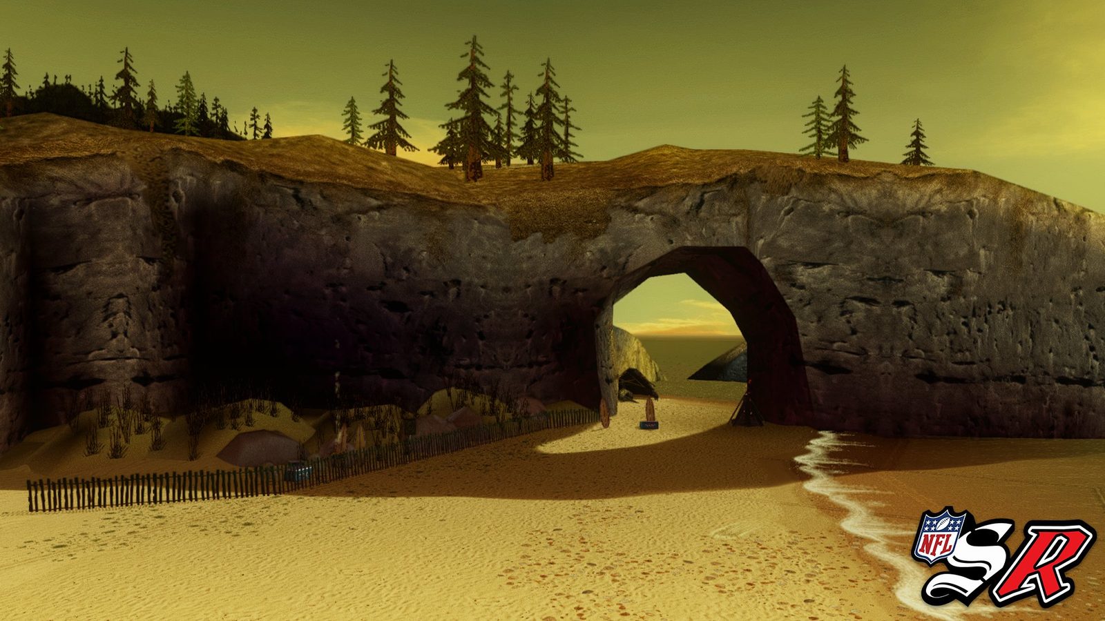 The Beach — sand court under a rock arch at sunset